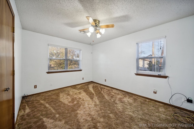 spare room featuring ceiling fan, a textured ceiling, and carpet floors