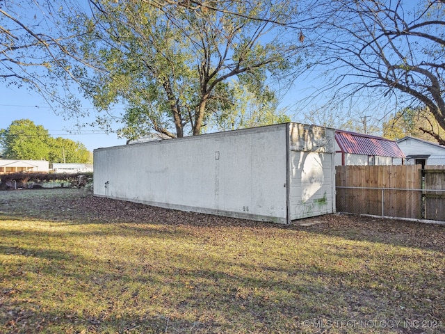 view of outbuilding with a yard