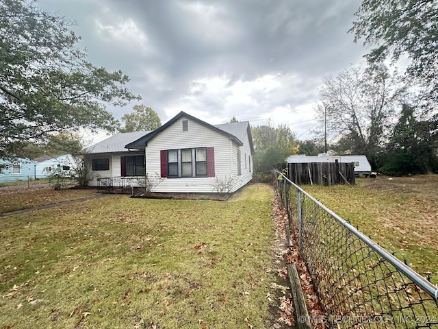 view of side of property with a yard