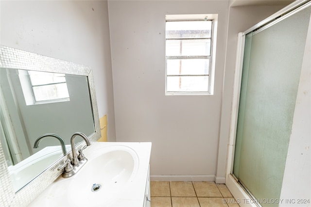 bathroom featuring walk in shower, vanity, and tile patterned floors