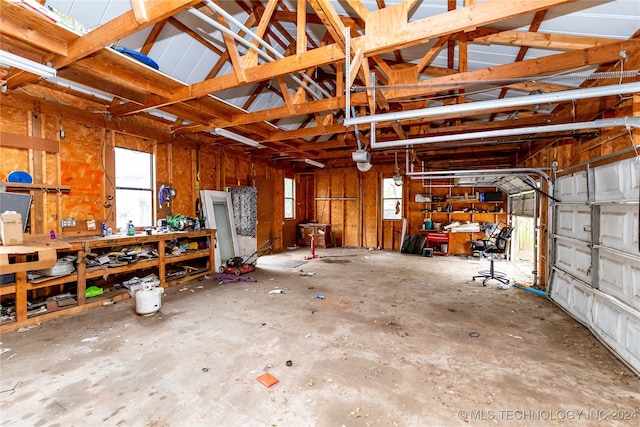 garage featuring a garage door opener and a workshop area