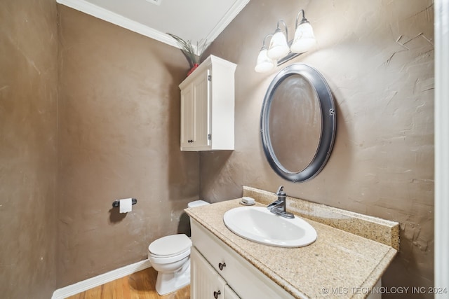 bathroom with toilet, vanity, hardwood / wood-style flooring, and crown molding