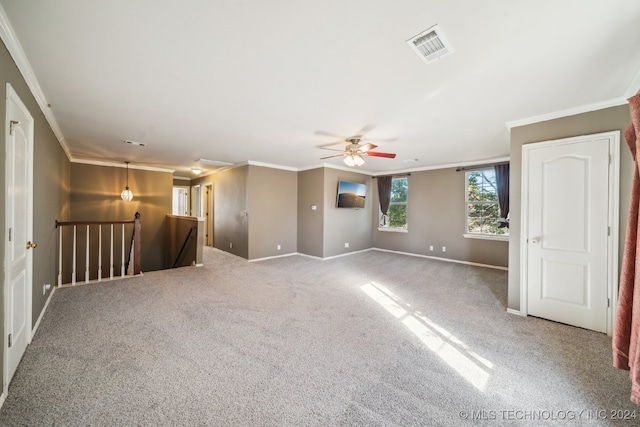 carpeted spare room featuring ceiling fan and ornamental molding