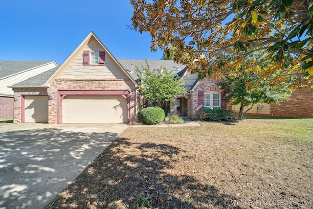 view of front of house with a garage and a front lawn