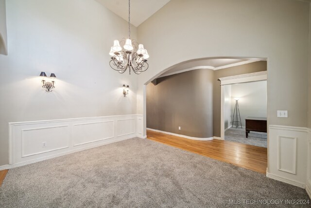 empty room featuring carpet flooring and high vaulted ceiling