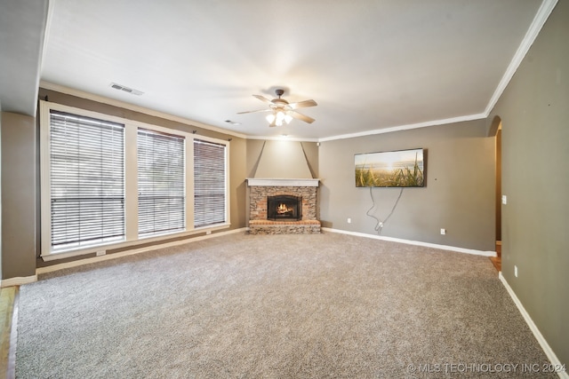 unfurnished living room featuring ornamental molding, carpet, ceiling fan, and a fireplace