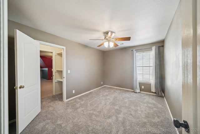 spare room with light colored carpet and ceiling fan