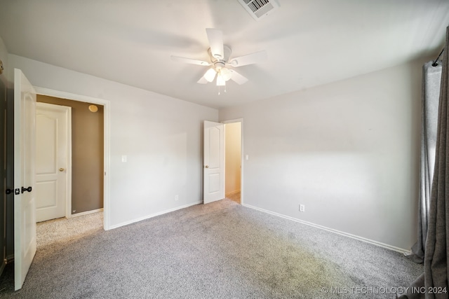 carpeted spare room featuring ceiling fan