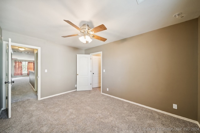 unfurnished bedroom with ceiling fan and light colored carpet