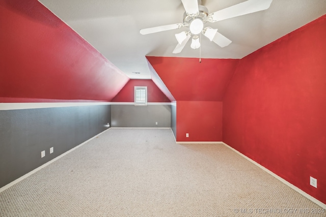 bonus room with carpet flooring, lofted ceiling, and ceiling fan