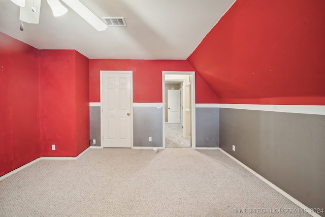 bonus room featuring light colored carpet, lofted ceiling, and ceiling fan