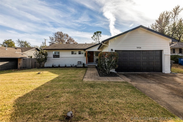 ranch-style home featuring a front lawn and a garage