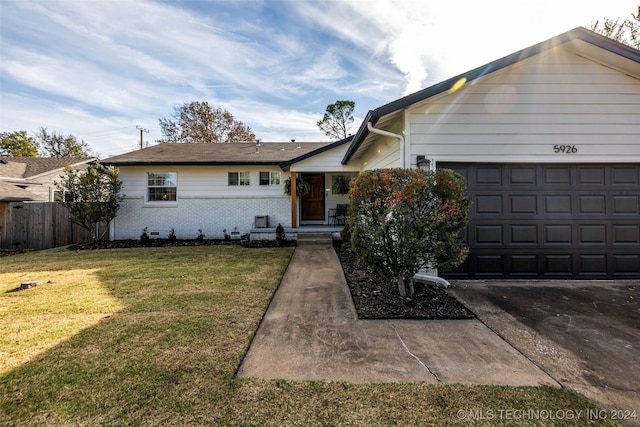 ranch-style house featuring a front yard and a garage