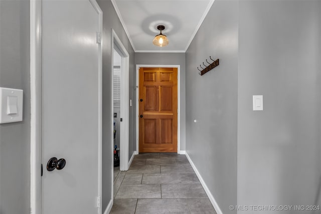 doorway with light tile patterned flooring and ornamental molding