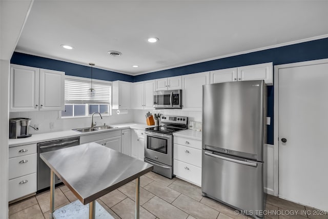 kitchen featuring pendant lighting, stainless steel appliances, white cabinetry, and sink