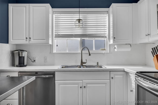 kitchen with stainless steel appliances, white cabinetry, sink, tasteful backsplash, and pendant lighting