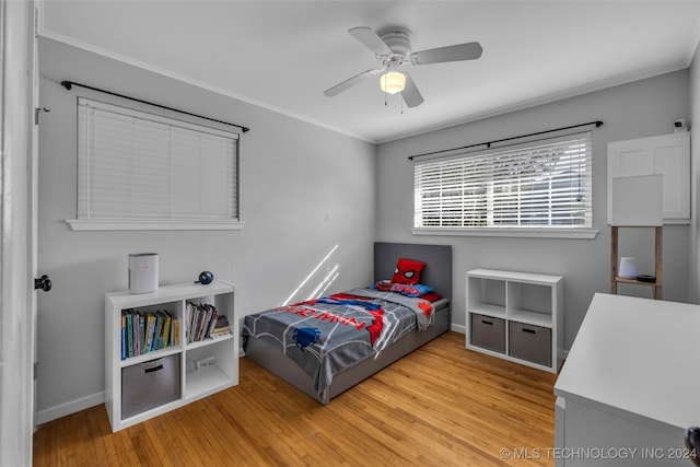 bedroom with ceiling fan and light hardwood / wood-style flooring