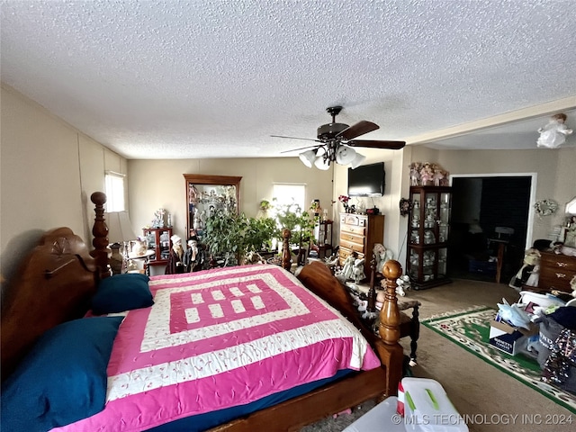 bedroom with ceiling fan, a textured ceiling, and carpet floors