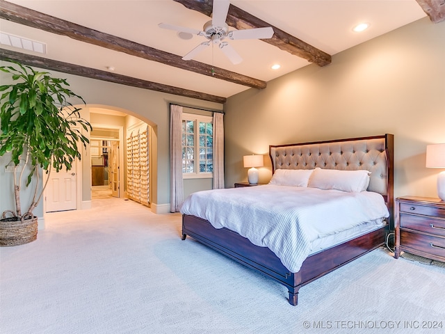 bedroom featuring beamed ceiling, visible vents, recessed lighting, arched walkways, and carpet flooring