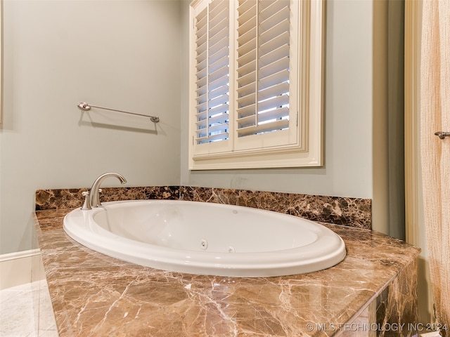 full bath featuring a tub with jets