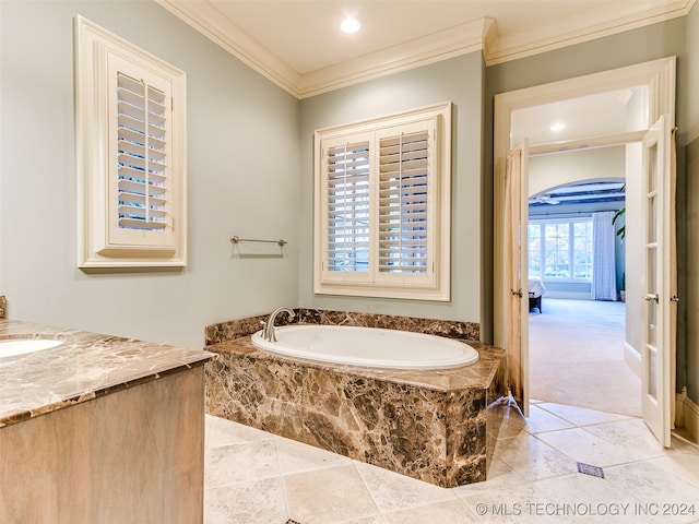 bathroom with a bath, recessed lighting, vanity, and ornamental molding