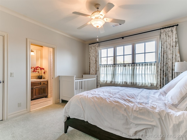 bedroom featuring visible vents, ensuite bath, crown molding, baseboards, and light colored carpet