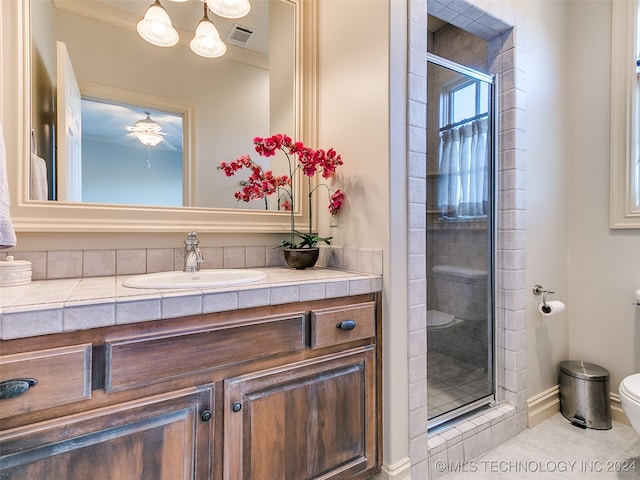 bathroom with visible vents, toilet, a shower stall, tile patterned flooring, and vanity