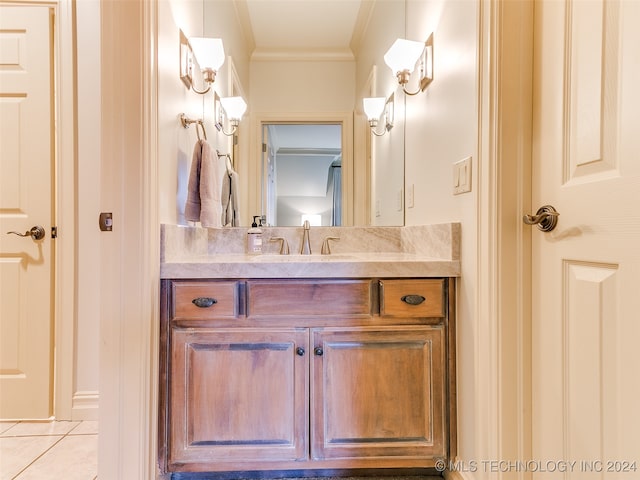 bathroom featuring tile patterned flooring, vanity, and crown molding