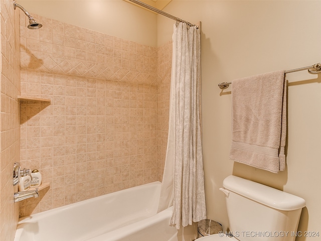 bathroom with toilet and shower / bath combo with shower curtain