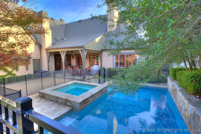 view of swimming pool featuring a fenced in pool, a grill, a patio, an in ground hot tub, and a ceiling fan