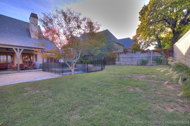 view of yard featuring a fenced in pool, a fenced backyard, and a patio area