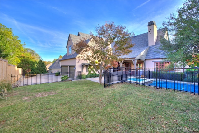 view of yard with a patio area, a fenced in pool, and fence