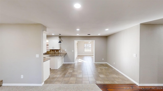 unfurnished living room with light tile patterned floors