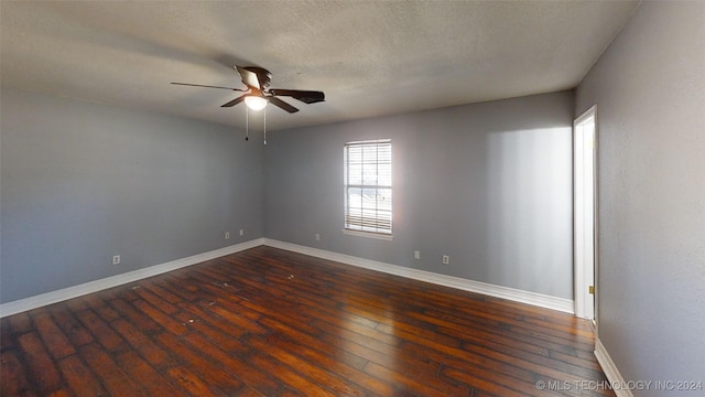 unfurnished room with a textured ceiling, ceiling fan, and dark wood-type flooring