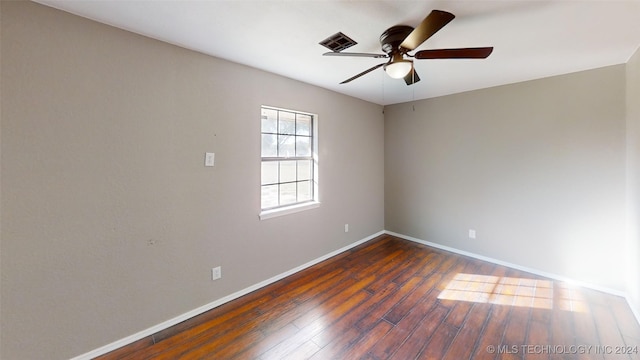 unfurnished room with ceiling fan and dark hardwood / wood-style flooring