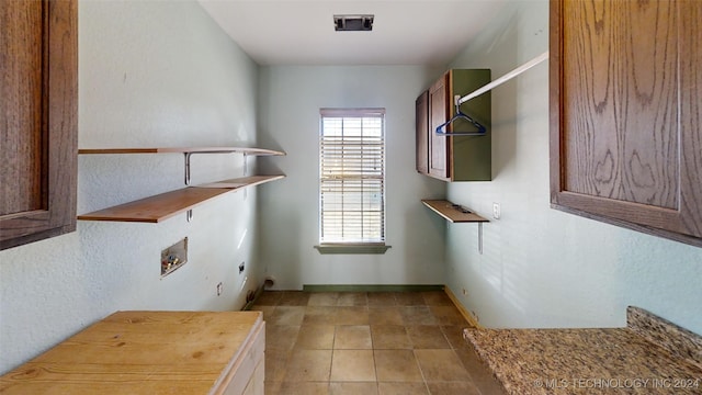 laundry room featuring hookup for an electric dryer, washer hookup, and cabinets