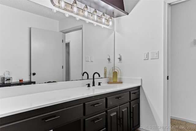 bathroom with vanity and a textured ceiling