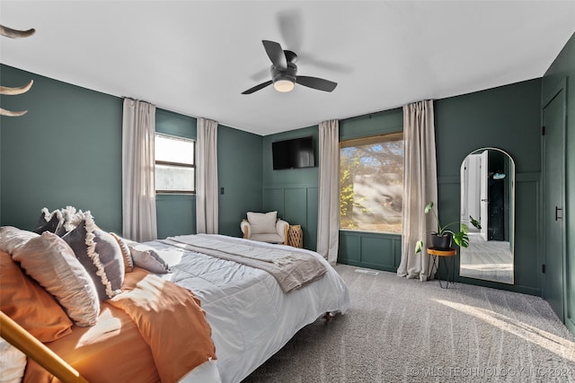 bedroom with carpet, multiple windows, and ceiling fan