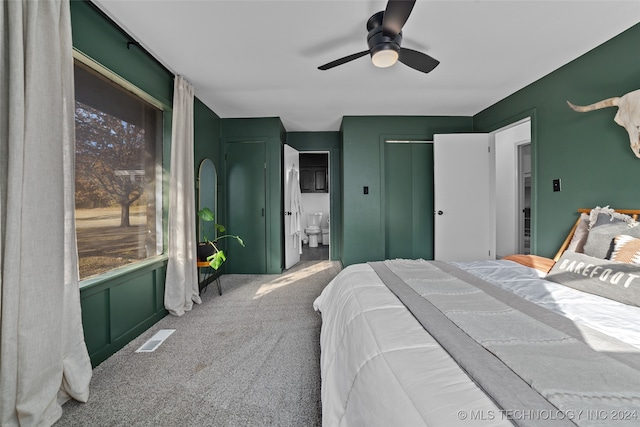 bedroom featuring carpet floors, multiple windows, and ceiling fan