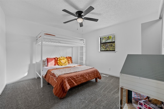 carpeted bedroom featuring ceiling fan and a textured ceiling