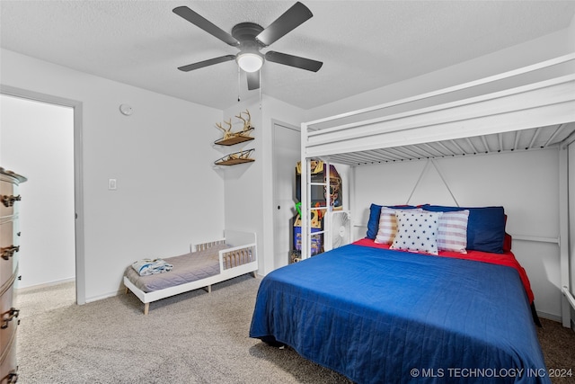 bedroom featuring ceiling fan, a textured ceiling, and carpet floors