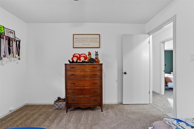 carpeted bedroom featuring a textured ceiling