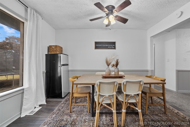 dining room featuring dark hardwood / wood-style flooring, a textured ceiling, and ceiling fan