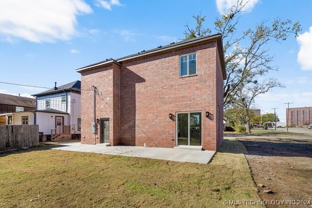 rear view of property with a patio area and a yard