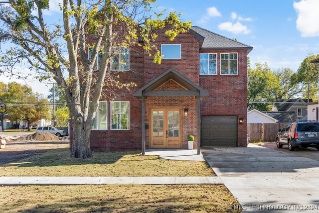 view of front property featuring a garage and a front yard