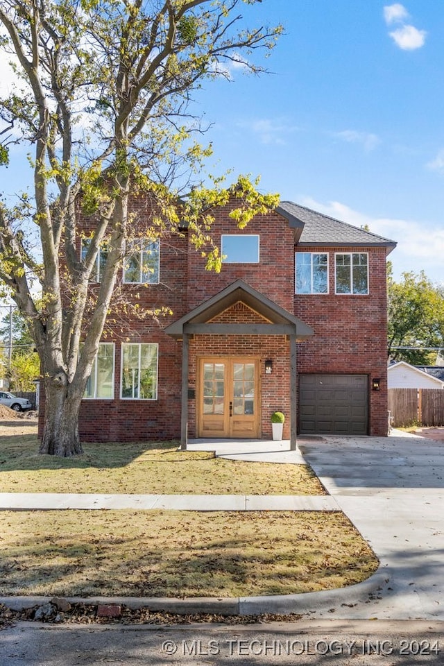 view of front of house featuring a garage and a front lawn