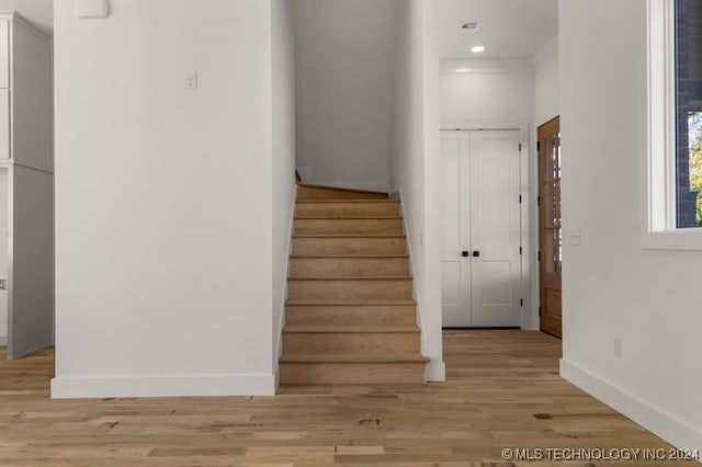 stairs with hardwood / wood-style floors