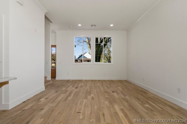 unfurnished room featuring light wood-type flooring and ornamental molding