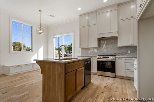 kitchen featuring white cabinets, black dishwasher, stainless steel range oven, sink, and an island with sink