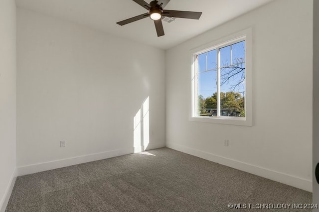 spare room featuring ceiling fan and carpet flooring